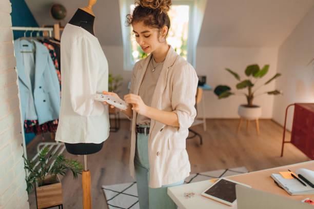 istock Young fashion designer working in her atelier 1374530529