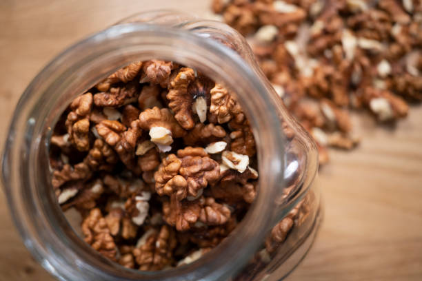 Walnut kernel in glass can stock photo