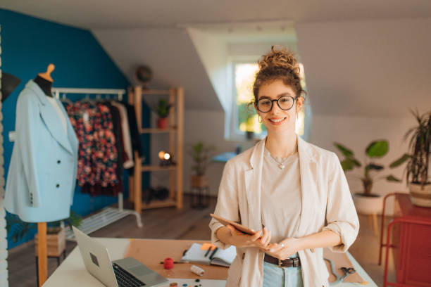istock Young fashion designer working in her atelier 1374535342