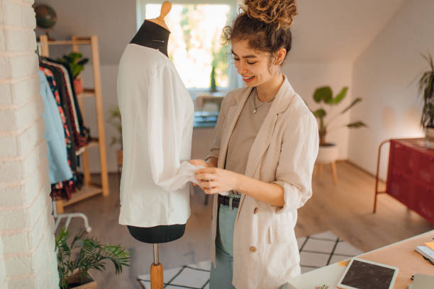 istock Young fashion designer working in her atelier 1374537019