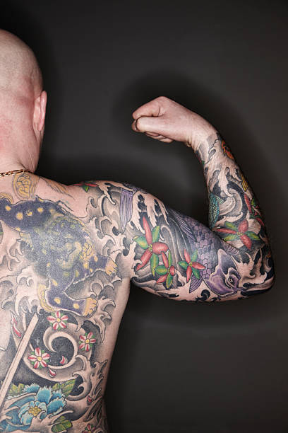 tattooed mann - tattoo men human arm shoulder stock-fotos und bilder