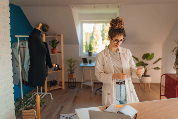 istock Young fashion designer working in her atelier 1374540712