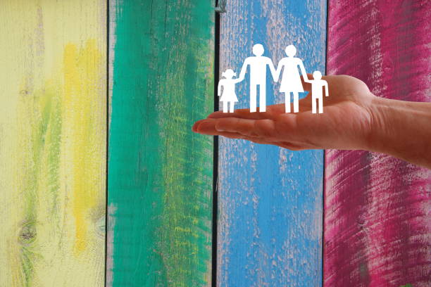 Family welfare concept with hand on wooden coloured background stock photo