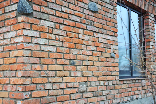 Red brick texture of the corner of the house. Red Brick wall for background or texture. Old red brick wall texture background