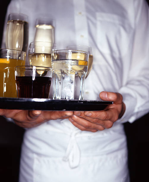 istock Waiter Holding Tray of Alcoholic Drinks 137454675
