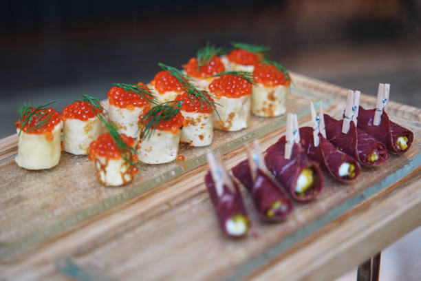 istock small appetizers with red caviar and meat rolls 1374561699