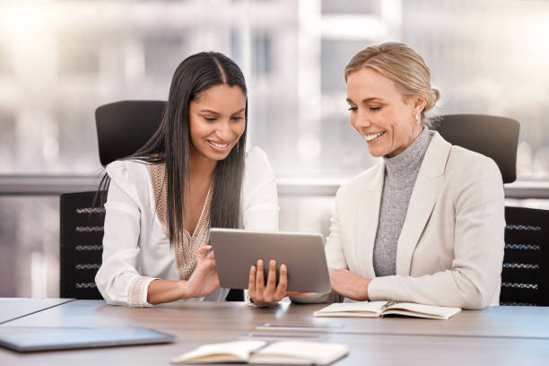 istock Shot of two businesswomen planning together while using a digital tablet 1374571060