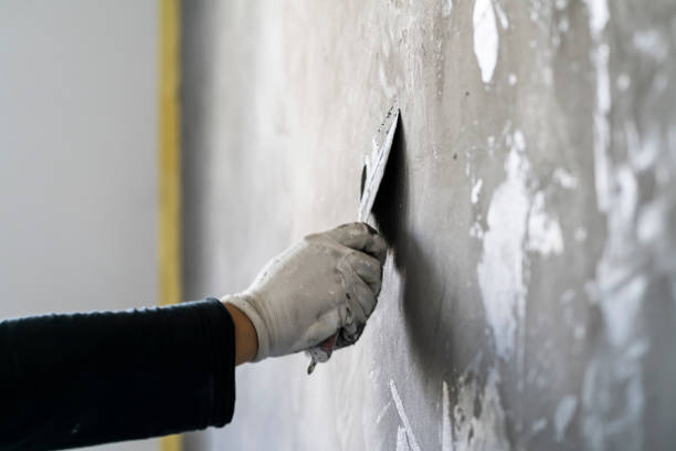 istock Close up of human hands working on concrete wall texture 1374573306