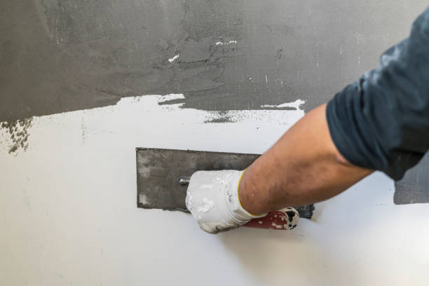istock Close up of human hands working on concrete wall texture 1374573840