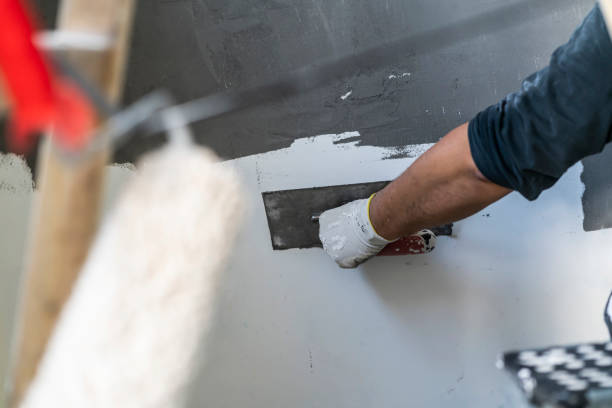 istock Close up of human hands working on concrete wall texture 1374573843