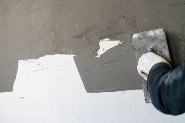 istock Close up of human hands working on concrete wall texture 1374574933