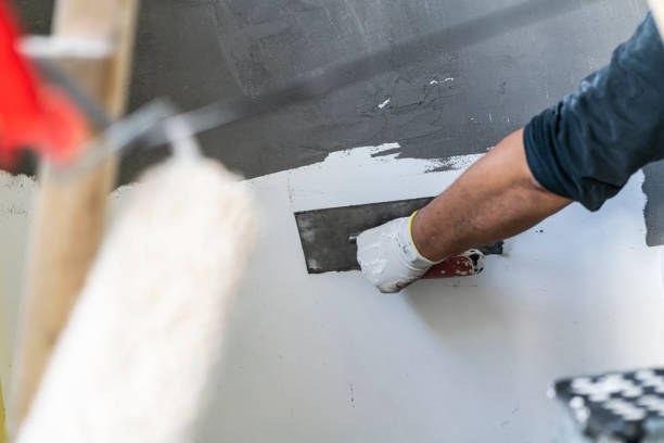 istock Close up of human hands working on concrete wall texture 1374576010