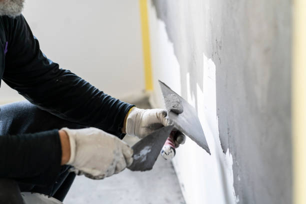 istock Close up of human hands working on concrete wall texture 1374576562
