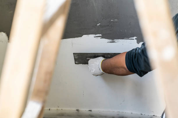 istock Close up of human hands working on concrete wall texture 1374577595
