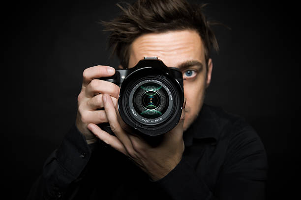 istock Close-up of photographer looking through camera 137458077