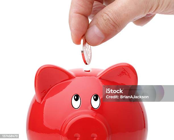 Inserting Coin Into A Piggy Bank Stock Photo - Download Image Now - Banking, Coin, Coin Bank