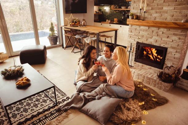 istock Beautiful evening enjoying wine by the fireplace 1374584783