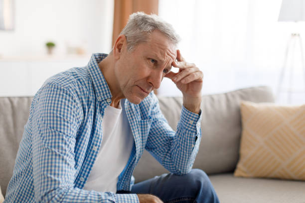istock Stressed mature man sitting on couch and thinking 1374586762