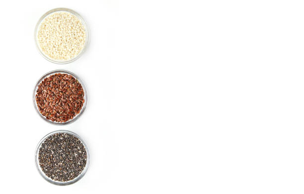 istock Chia, flax, sesame in glass bowls isolated on white background 1374596277