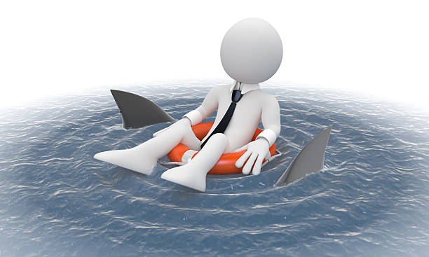 istock Businessman floating in a life preserver with sharks around 137460298