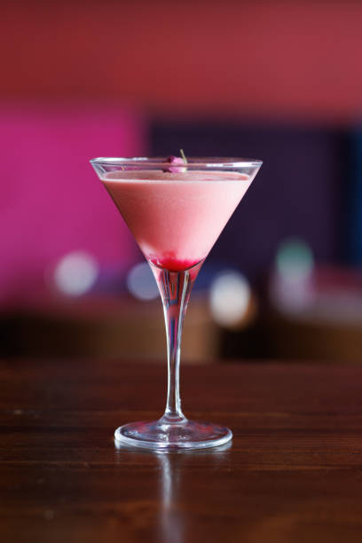 istock Berry fruit smoothie in martini glass on bar table 1374606783