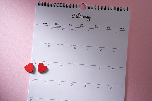 wall calendar on february against pink background