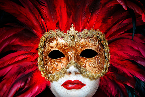 Store window decorated with Venetian style Carnival mask.  Spanish culture, tradition. Galicia, Spain.