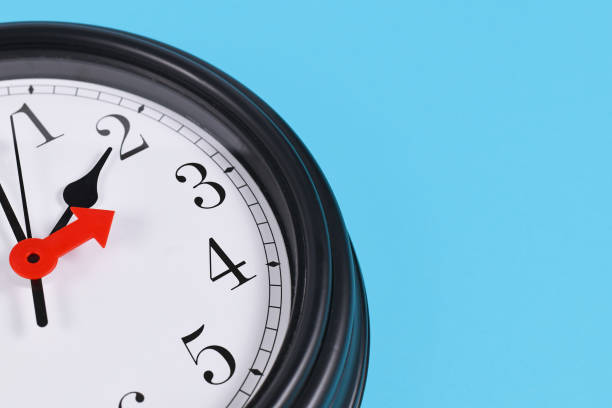 Time change for summer daylight saving in Europe concept. Red arrow symbolizing clock turned forward by one hour