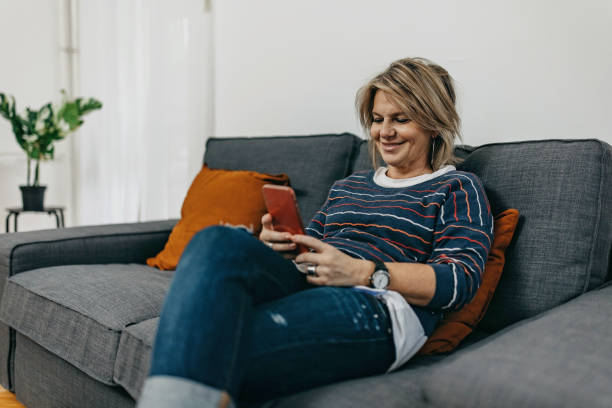 istock Mature woman using technology at home 1374647523