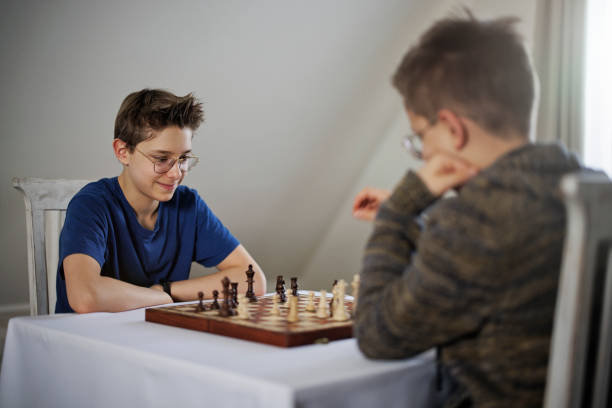istock Teenage boys playing chess together 1374665205