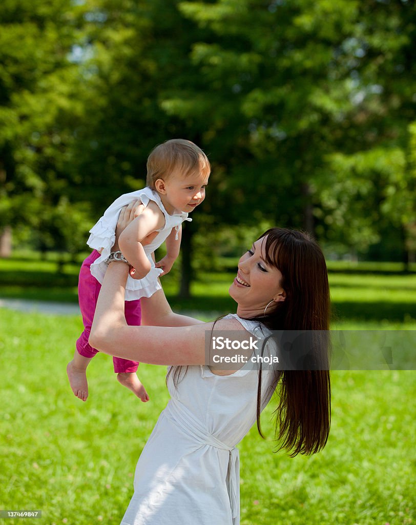 Young Mother In A Park Playing With Her Baby Stock Photo ...