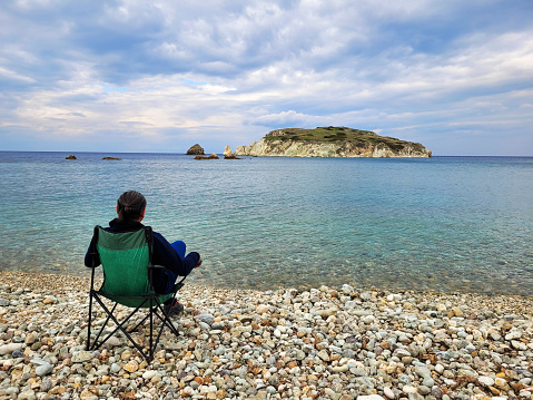 man sitting alone on the beach