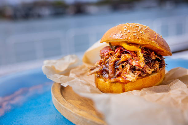 istock Bacon burger with cheese in bun, served on wooden board 1374703506