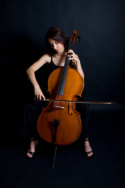 istock Beautiful woman cellist with her instrument 137470381