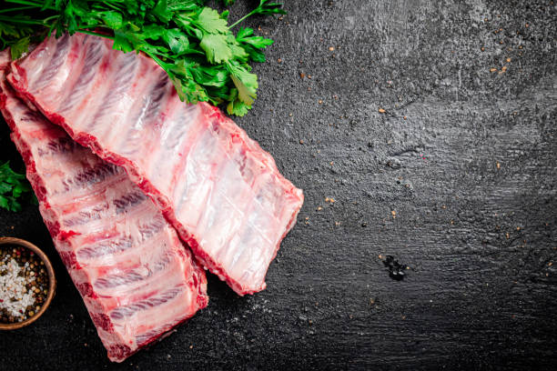 istock Raw ribs with herbs and spices. 1374711055