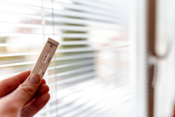 istock Positive result of antigen test holding in hand and looking from window outside due quarantine 1374716407