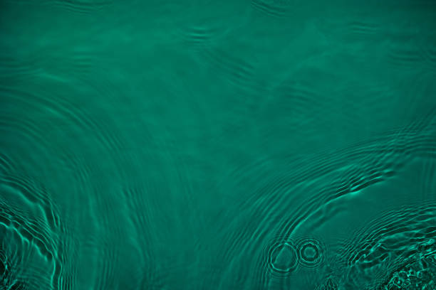 istock transparent dark green colored clear calm water surface texture 1374718564