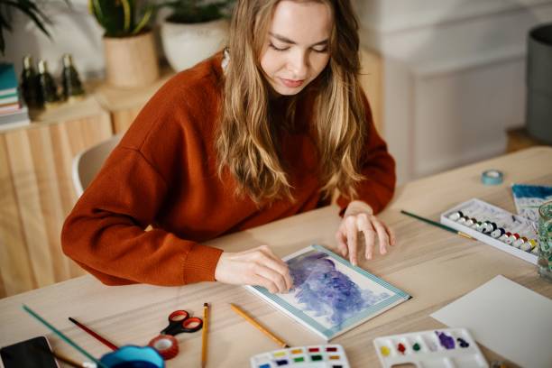 istock Talented woman creating beautiful watercolor design. 1374727255