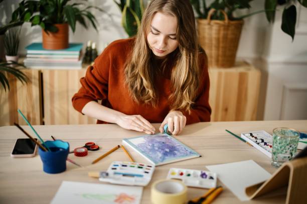 Talented woman creating beautiful watercolor design.
