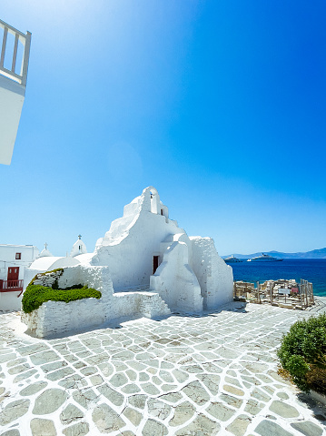 Iconic church of Panagia Paraportiani, Mykonos. One of the most photographed churches in the world. Paraportiani means ‘standing next to the entrance door’ - the church was next to the castle (Kastro) door. Built in 14th century. Mykonos island, Cyclades, Greece.