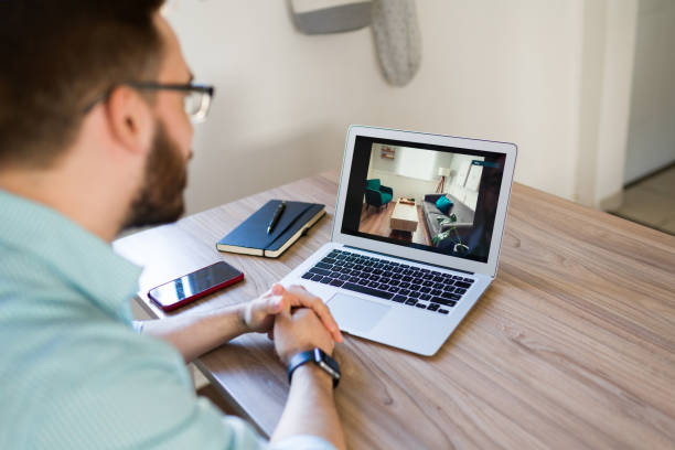 istock Client watching a video home tour 1374736386