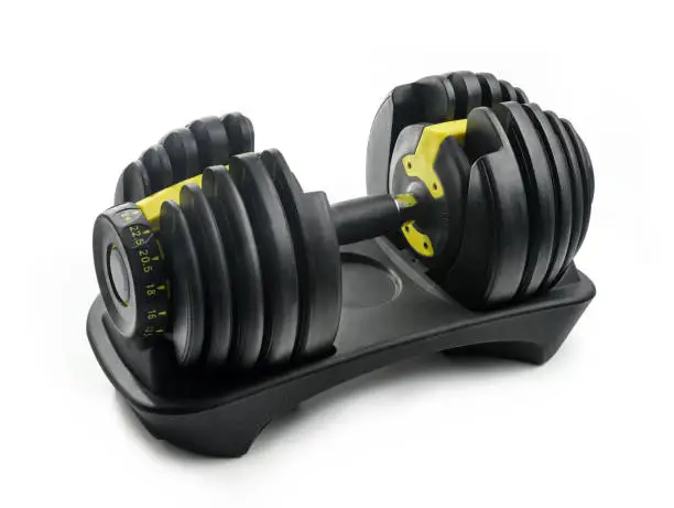 Photo of Modern adjustable dumbbell isolated on white background.