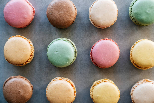 istock Multicolored macaroons on a concrete background. View from above. 1374747438