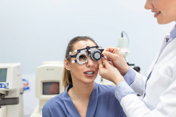 istock Eye health cheking with ophthalmological equipment in the laboratory. Using special device oculist trying to improve vision of young pretty girl. Working with medical devices for eye health. 1374769737