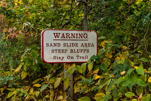 Warning Sand Slide Area Steep Buffs Stay on trail sign, Sleeping Bear National Lakeshore, Michigan, USA.
