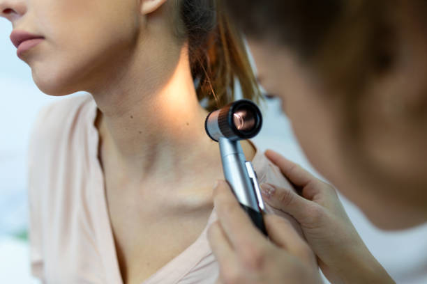 Doctor dermatologist examines skin of patient. Dermatoscopy, prevention of melanoma, skin cancer. Doctor dermatologist examines skin of patient. Dermatoscopy, prevention of melanoma, skin cancer. skin cancer stock pictures, royalty-free photos & images