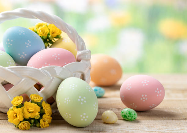 istock Easter eggs and flowers in a basket and on a wooden table 1374779939