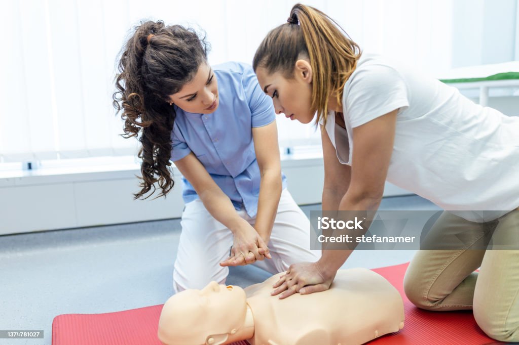 Demonstrating CPR (Cardiopulmonary resuscitation) training medical procedure on CPR doll in the class.Doctor and nurse students are learning how to rescue the patient.First aid for safe life concept. CPR Stock Photo