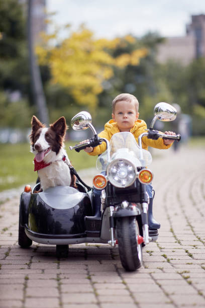 istock Happy little boy driving a toy motorcycle 1374786529