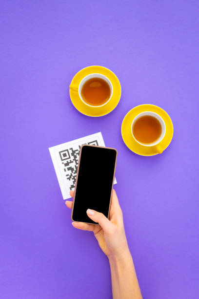 istock Top view Hand's customer scan QR code for online menu service at table in restaurant. New contactless technology lifestyle protection coronavirus pandemic in restaurant. 1374786808